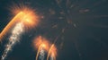 Bright golden fireworks exploding in the night sky with white sparks and trails Royalty Free Stock Photo