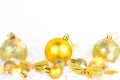 Bright golden Xmas decorations ribbons, baubles, ornament on white snow background with copy space. Christmas and New Year Royalty Free Stock Photo