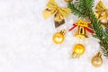 Bright golden and yellow Christmas decorations ribbons, baubles, ornament flat lay on white artificial snow background Royalty Free Stock Photo