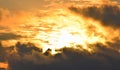 Bright Golden Yellow Orange Sunlight from Dark Grey Clouds in Sky - Warm Skyscape - Heat and Solar Energy Royalty Free Stock Photo