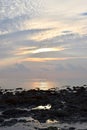 Bright Golden Yellow Sunlight with Pattern of White Clouds in Morning Sky at Stony Beach - Natural Background Royalty Free Stock Photo