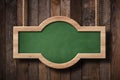 Bright green blackboard with rounded shape hanging on ropes with wood planks background