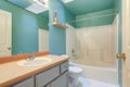 Bright green blue Bathroom with white tub and shower combo. Royalty Free Stock Photo