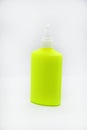 A bright green bottle of glue on a white background. Beautiful tube close-up. Green plastic bottle