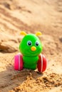 Bright green caterpillar toy in the sandbox. Royalty Free Stock Photo