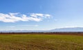 bright green field, beautiful clear blue sky in white blurry clouds, Bulgaria Royalty Free Stock Photo