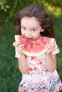 Bright green grass. Little beautiful girl. Juicy, delicious, red