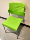 A bright green plastic chair had a backrest in an empty room. Royalty Free Stock Photo