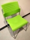 A bright green plastic chair had a backrest in an empty room. Royalty Free Stock Photo