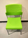 A bright green plastic chair had a backrest in an empty room. Royalty Free Stock Photo