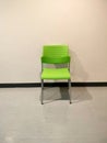 A bright green plastic chair had a backrest in an empty room. Royalty Free Stock Photo