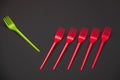 Bright green and red forks isolated on black