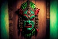 bright green-red tiki mask of indians hanging on wooden wall