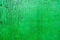 Bright green saturated relief texture beautifully painted with wood paint with vertical stripes, cracks, beautiful pattern Royalty Free Stock Photo