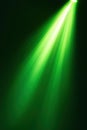 Bright green spotlight illuminating dark background with vibrant light rays Royalty Free Stock Photo