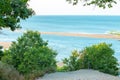 Bright green trees and sand shore with ocean background landscape Royalty Free Stock Photo