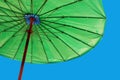 Bright green umbrella against a blue sky Royalty Free Stock Photo