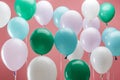 Bright green, white and blue party decorative balloons on pink background. Royalty Free Stock Photo