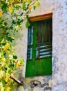 Bright Green Wooden Door on Old Stucco Building, Greece