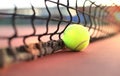 Bright greenish yellow tennis ball on clay court