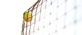 Bright greenish yellow tennis ball hitting the net