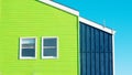 bright green building detail on blue background with two symmetric wondows Royalty Free Stock Photo