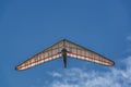 Bright hang glider wing silhouette from below