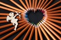 Bright heart-shaped pencils and an angel Royalty Free Stock Photo