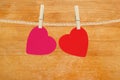 Bright hearts hanging on rope on wooden