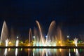 Bright high jets of singing and dancing fountains in the night sky on the embankment of the city of Batumi.