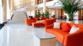 Bright Hotel Lobby with Orange Sofas and Grand Royalty Free Stock Photo