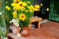 Bright huge yellow bouquet in a vase on the porch in the garden and Park