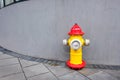 Bright hydrant in a cityscape on a gray wall Royalty Free Stock Photo