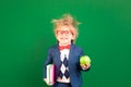 Bright idea! Happy child student against green chalkboard