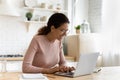 Happy smiling latin female writer in glasses typing on pc Royalty Free Stock Photo