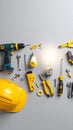 Bright idea and professional construction tools including drill screwdriver light bulbs hard hat and measuring tape Royalty Free Stock Photo