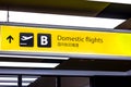 Bright illuminated yellow and black airport signs with arrows and plane icons and the title in Chinese: Domestic flights. Royalty Free Stock Photo