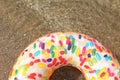 Bright inflatable doughnut ring floating on sea water. Space for text
