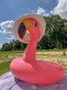 a bright inflatable pink flamingo on the beach in summer Royalty Free Stock Photo
