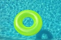 Bright inflatable ring floating in swimming pool, above view Royalty Free Stock Photo