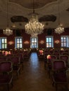 Bright interior of a modern concert hall with a stage and rows of comfortable leather chairs, a stage and acoustic