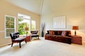 Bright ivory living room with high vaulted ceiling and french wi Royalty Free Stock Photo