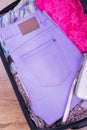 Bright jeans and shirt in suitcase