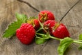 The bright, juicy and delightful berries of raspberry stationed oneself on a log