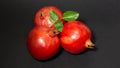 Bright juicy pomegranate fruits, black background, close up Royalty Free Stock Photo