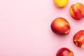 Bright juicy ripe nectarines peaches on a pink background top view. Food organic background. Summer fruits, food for a healthy Royalty Free Stock Photo