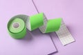 Bright kinesio tape in roll on lilac background