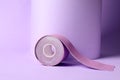 Bright kinesio tape in roll on lilac background