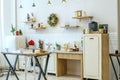 Bright kitchen interior with Christmas decor and Christmas wreath. Kitchenware Royalty Free Stock Photo