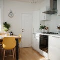 Bright kitchen interior in modern apartment for rent sale and blogging Kettle and utensils on white furniture small Royalty Free Stock Photo